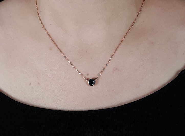 A lady's Minimalist 14k rose gold natural 0.95 carat Montana blue sapphire bezel pendant on chain.