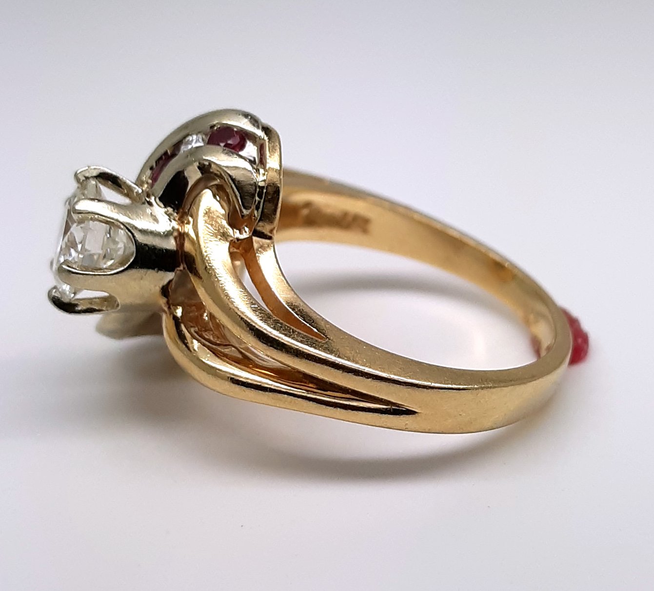 A lady’s estate 14k two tone split shank diamond fashion ring with diamond and ruby accents. Circa: 1990s