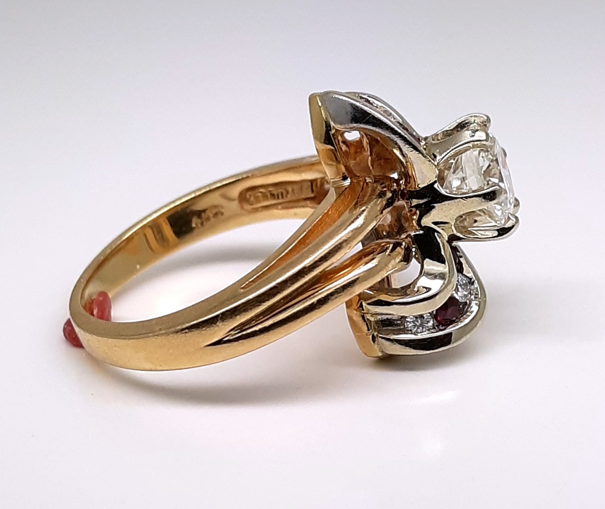 A lady’s estate 14k two tone split shank diamond fashion ring with diamond and ruby accents. Circa: 1990s
