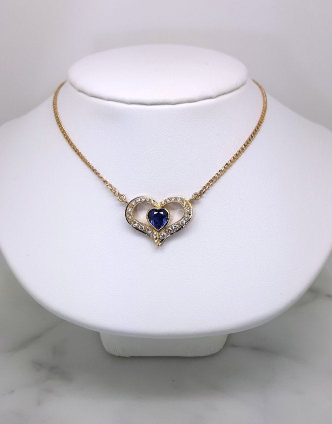 A lady's estate 14k yellow gold 0.73 carat heart shaped Montana Yogo Sapphire and diamond accented pendant on chain.
