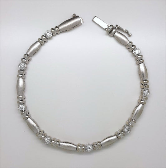 A Lady’s estate 14k white gold diamond accented bead and reel line bracelet.