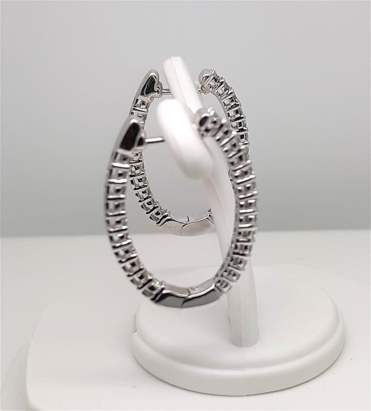 A Lady’s estate pair of 14k white gold “inside – outside” diamond hoop earrings with an approximate total diamond weight of 1.00 carat.