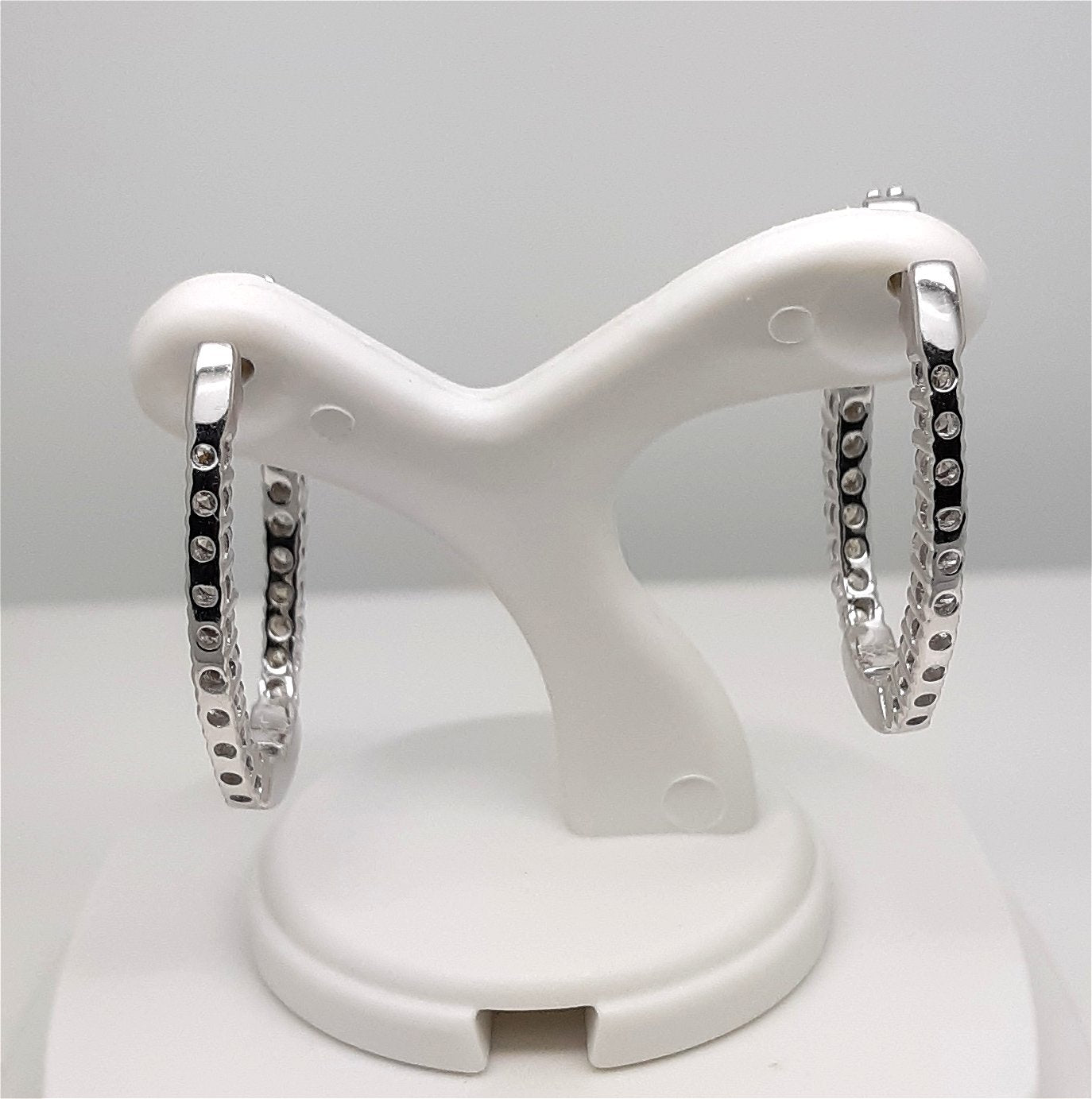 A Lady’s estate pair of 14k white gold “inside – outside” diamond hoop earrings with an approximate total diamond weight of 1.00 carat.