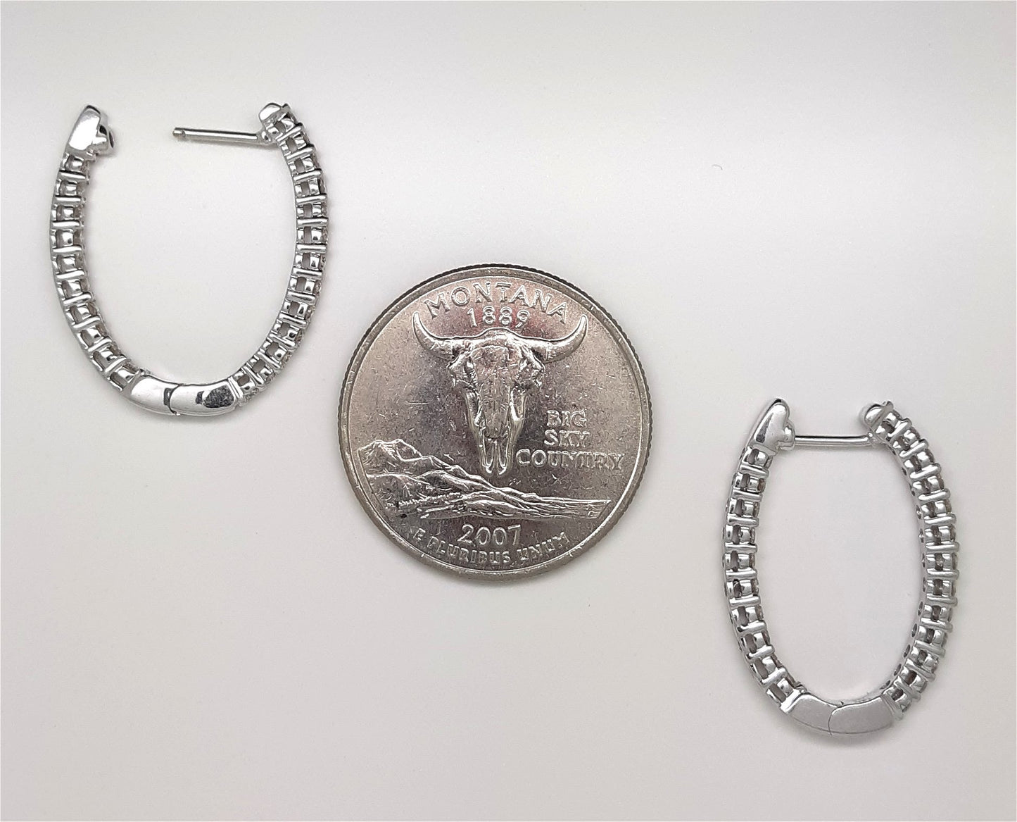 A Lady’s estate pair of 14k white gold “inside – outside” diamond hoop earrings with an approximate total diamond weight of 1.00 carat.