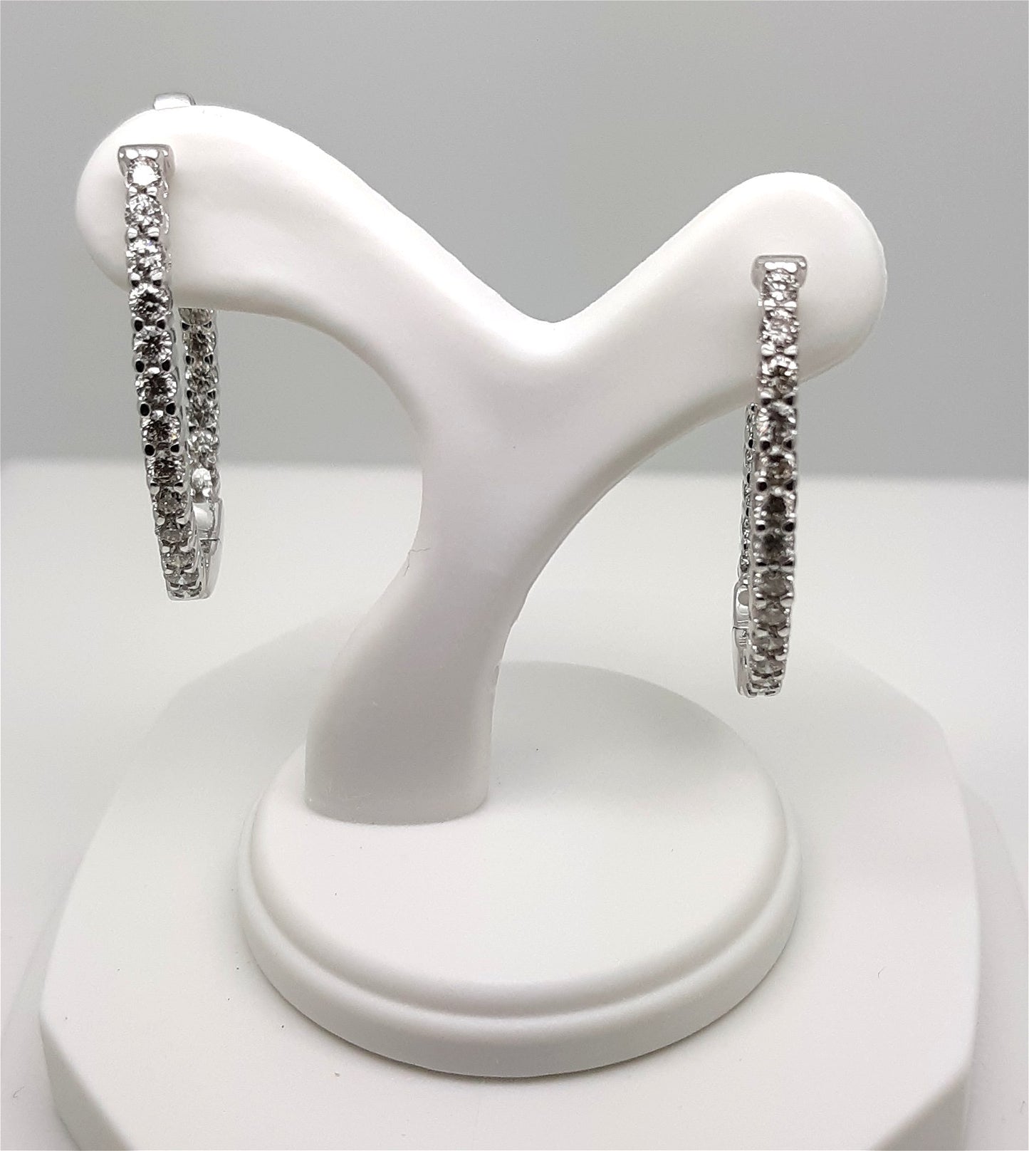 A Lady’s estate pair of 14k white gold “inside – outside” diamond hoop earrings with an approximate total diamond weight of 1.00 carat.