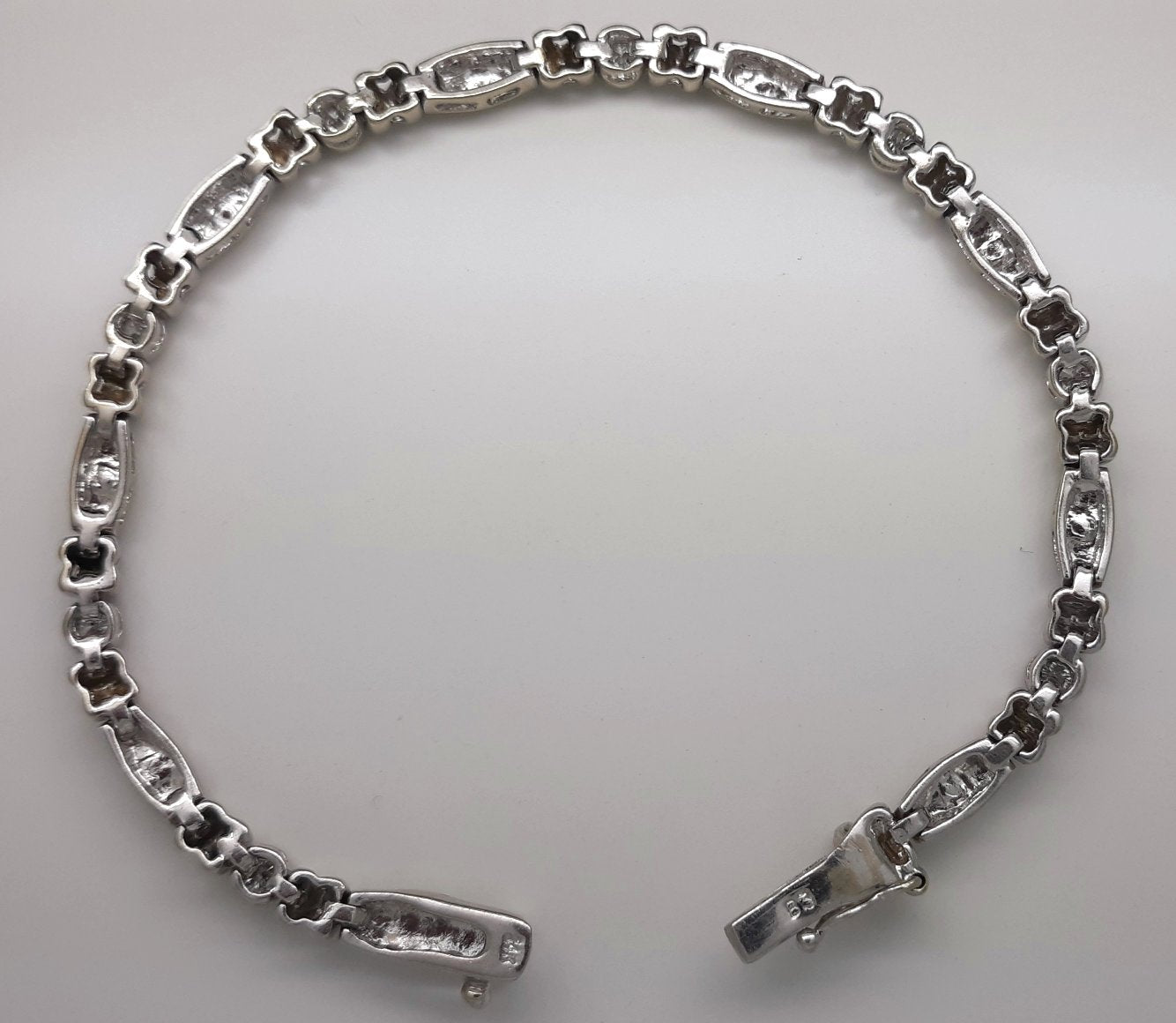 A Lady’s estate 14k white gold diamond accented bead and reel line bracelet.