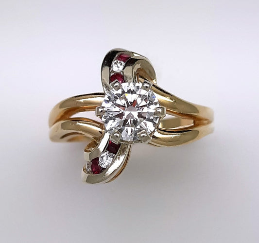 A lady’s  estate 14k two tone split shank diamond fashion ring with diamond and ruby accents. Circa: 1990s