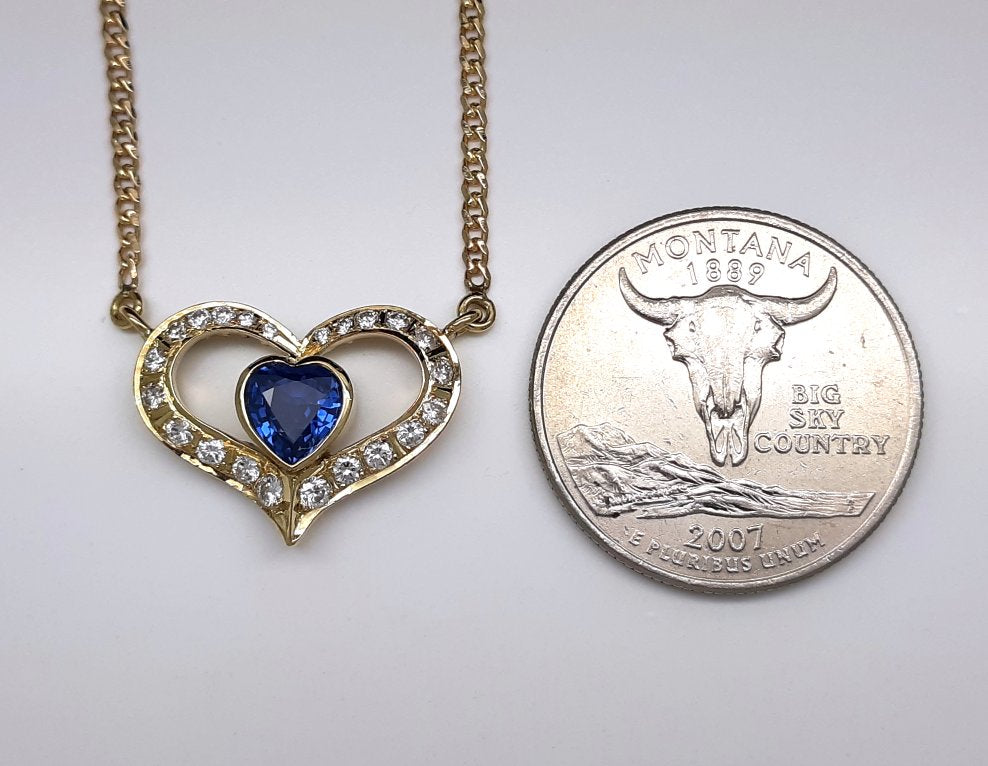 A lady's estate 14k yellow gold 0.73 carat heart shaped Montana Yogo Sapphire and diamond accented pendant on chain.